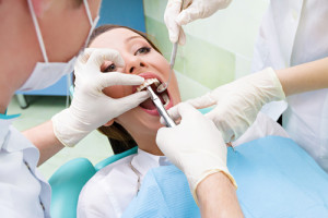 Female patient in dentist office getting tooth procedure